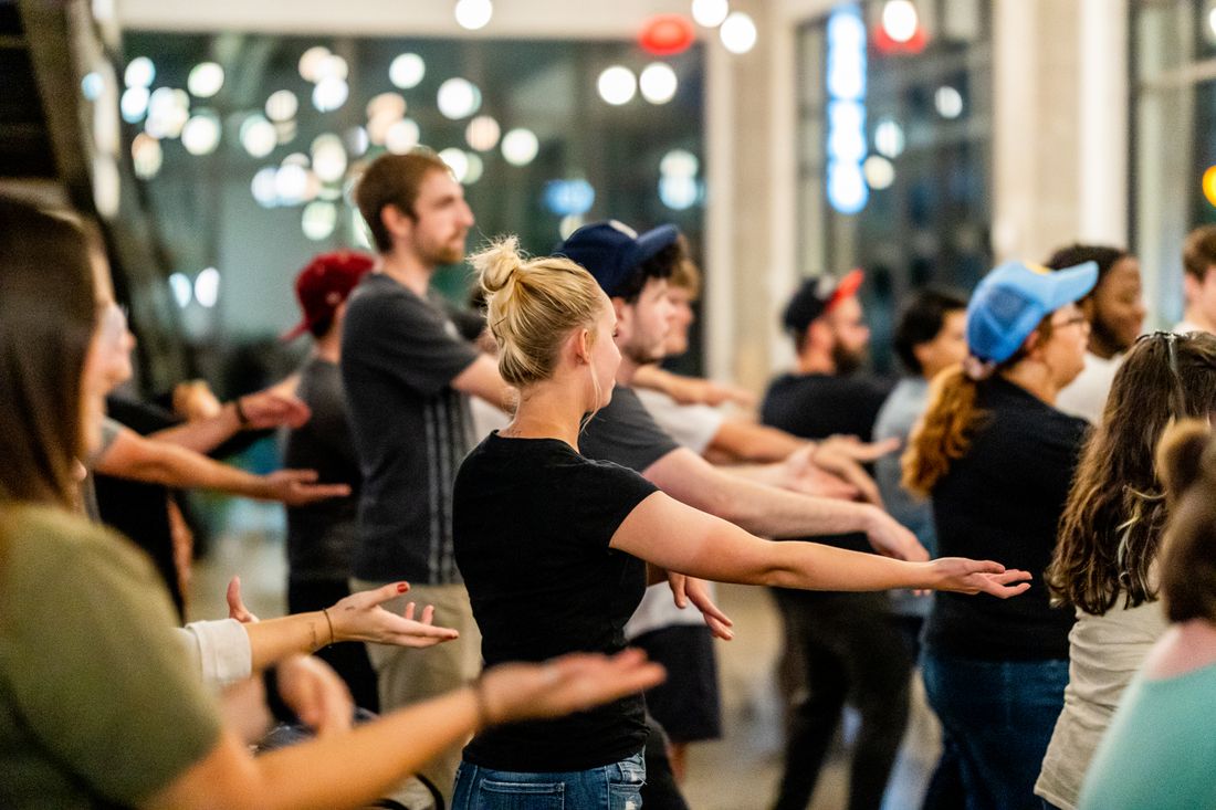 Dancers rehearsing together in a bright studio