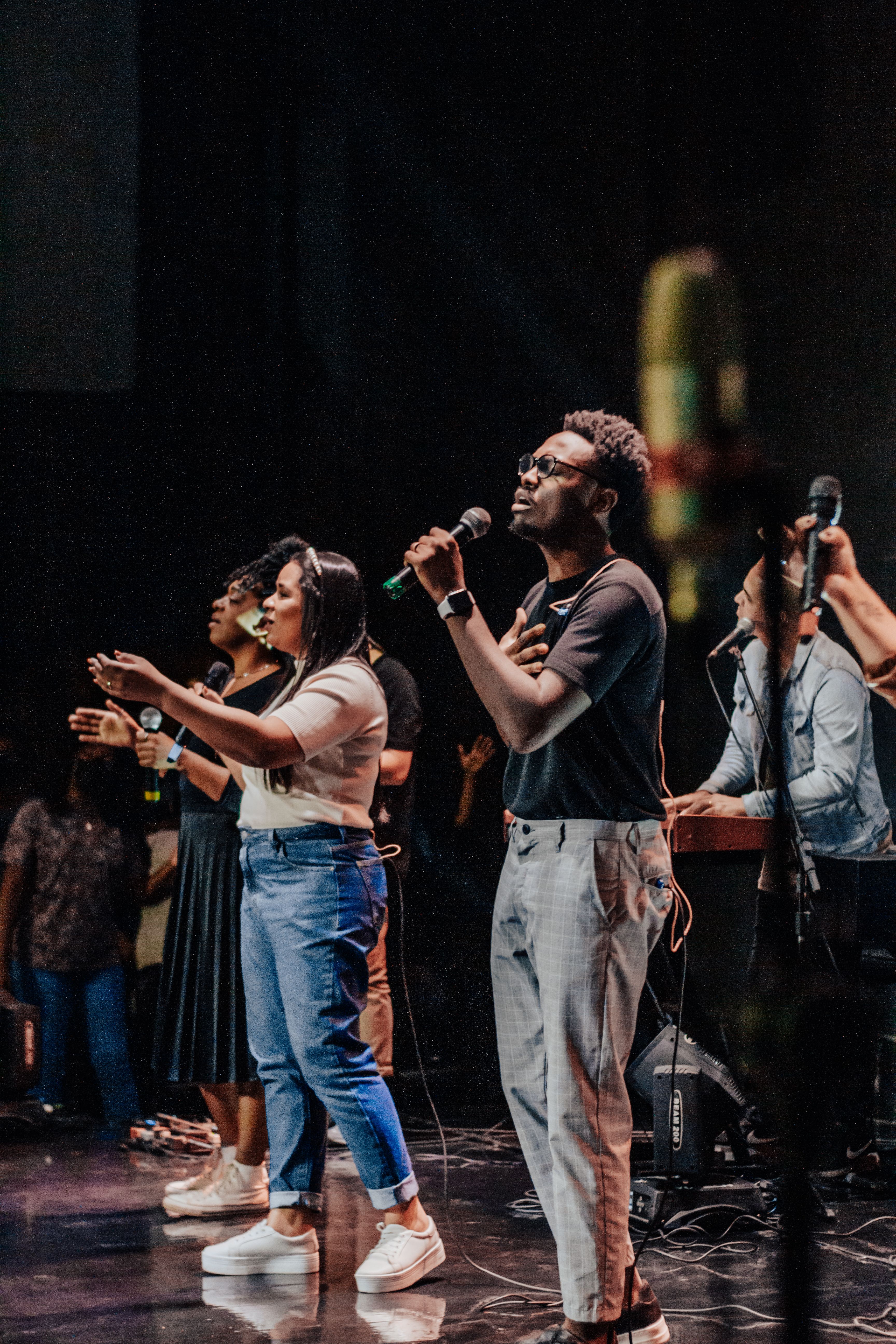Vocalists performing together with handheld microphones